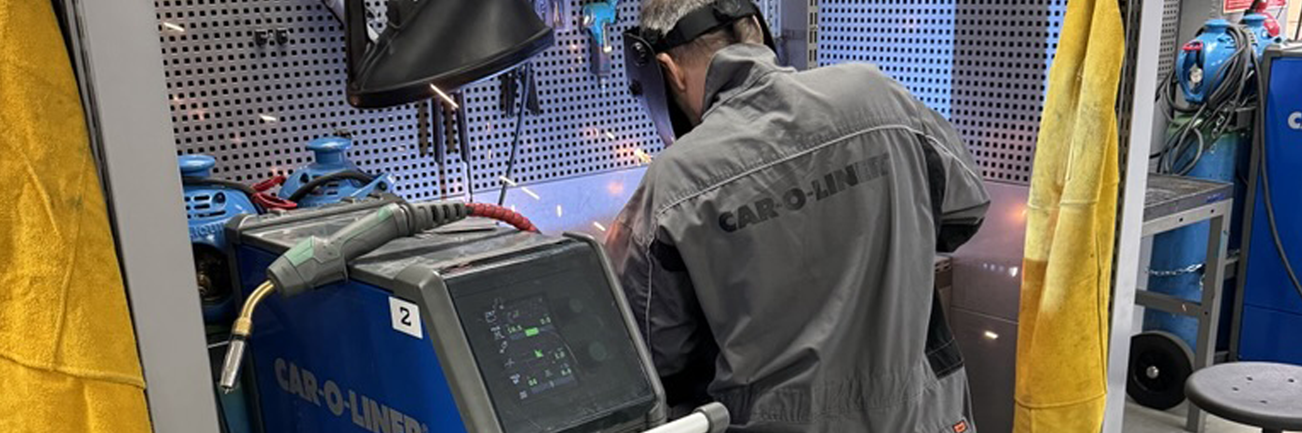 A technician performing a weld with Car-O-Liner welding equipment