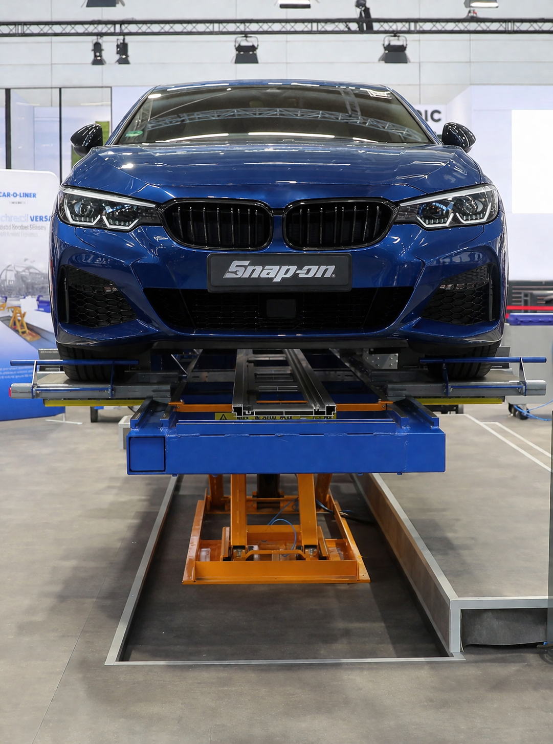a blue car on Benchrack Versa lifted off the ground