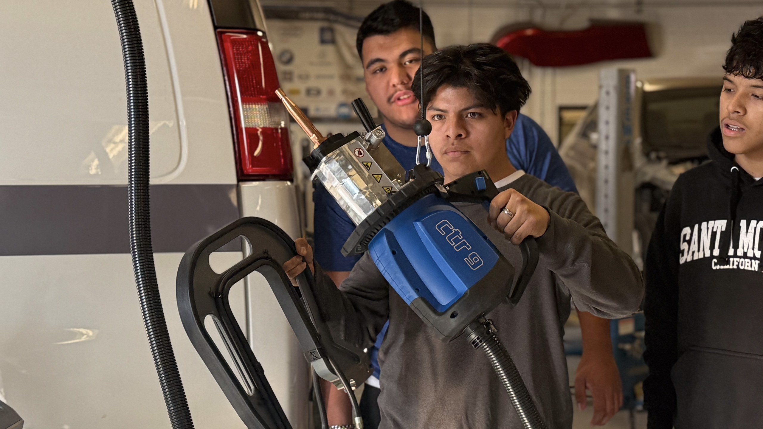 Students holding CTR9 spot welder