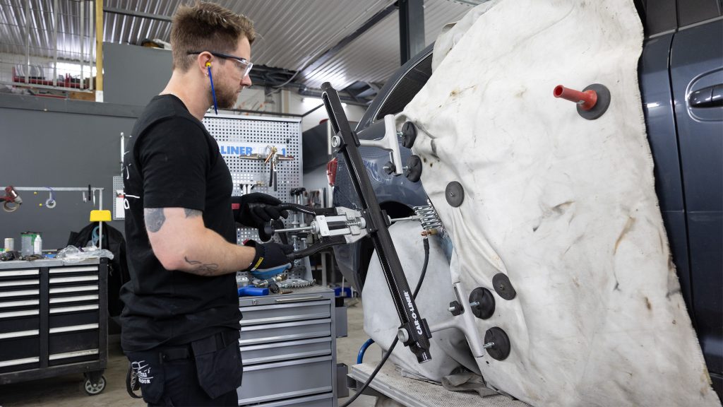 A technician performing a body repair.